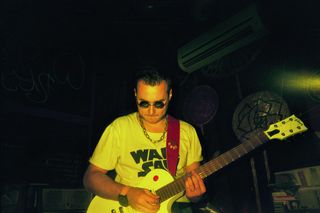 Lead guitarist of the Calculators wearing WARSAW T-shirt.